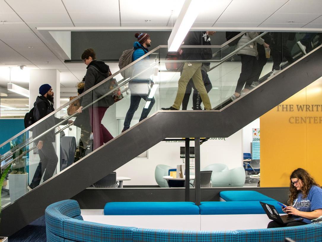 Students ascending and descending central library stairwell